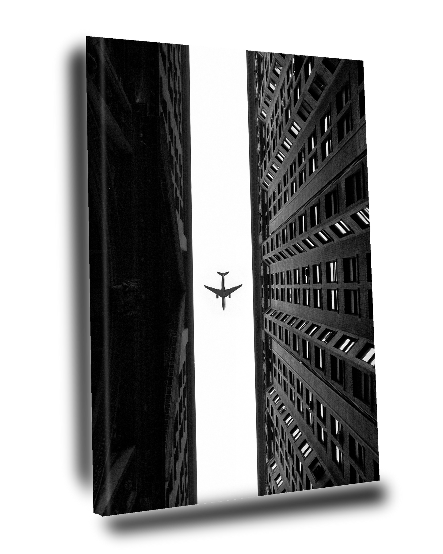 Cuadro Decorativo Avión volando sobre dos edificios Blanco y Negro